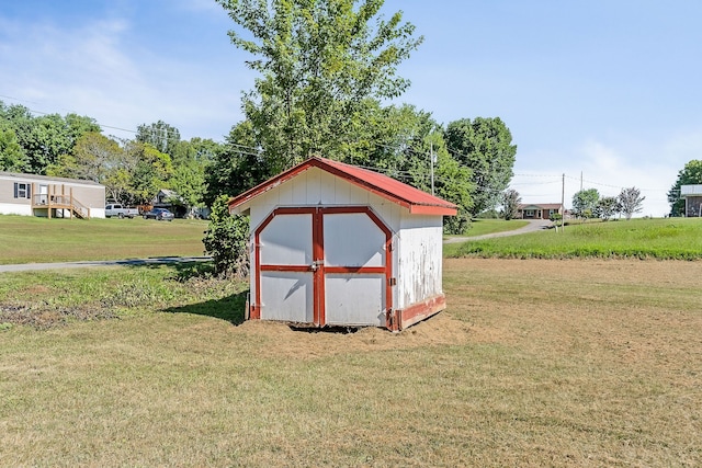 view of outbuilding featuring a yard