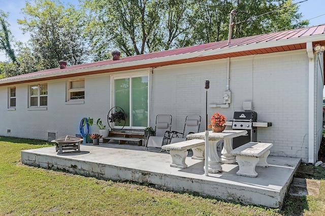 back of house with a patio, a fire pit, and a yard