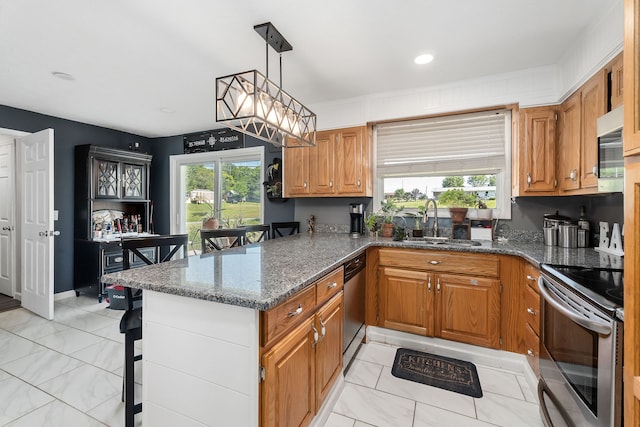 kitchen with kitchen peninsula, plenty of natural light, light tile patterned floors, and dark stone countertops