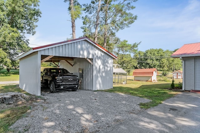 garage with a carport and a yard