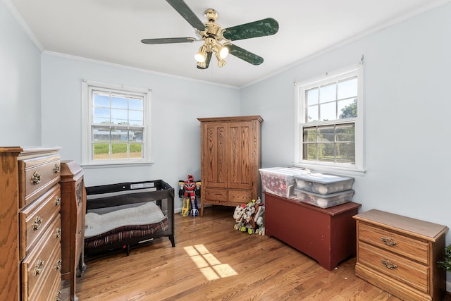 bedroom featuring ceiling fan, crown molding, and hardwood / wood-style flooring