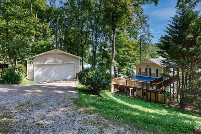 exterior space with a garage and an outbuilding