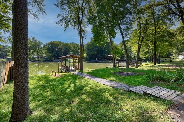 surrounding community featuring a yard, a gazebo, and a water view