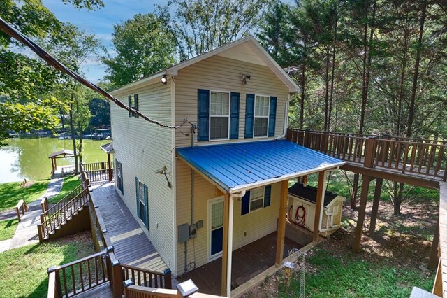 rear view of property featuring a wooden deck