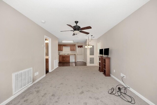 unfurnished living room featuring ceiling fan and light carpet