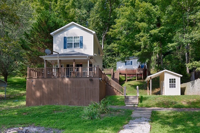 view of front of home featuring an outbuilding and a front lawn