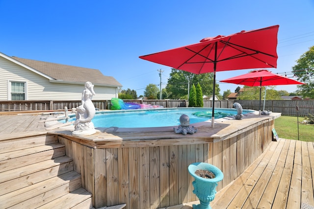 view of swimming pool with a deck