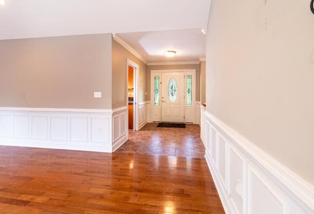 entrance foyer featuring hardwood / wood-style floors and ornamental molding