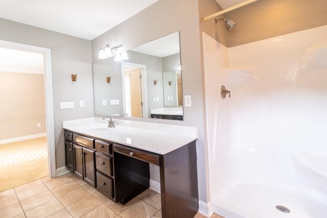 bathroom featuring a shower, vanity, and tile patterned floors