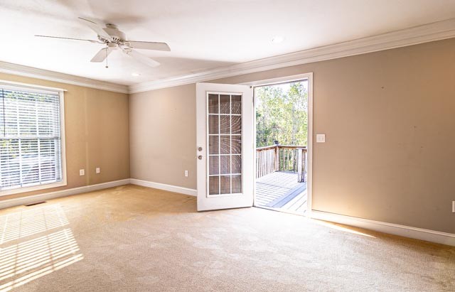 spare room with crown molding, french doors, ceiling fan, and light carpet