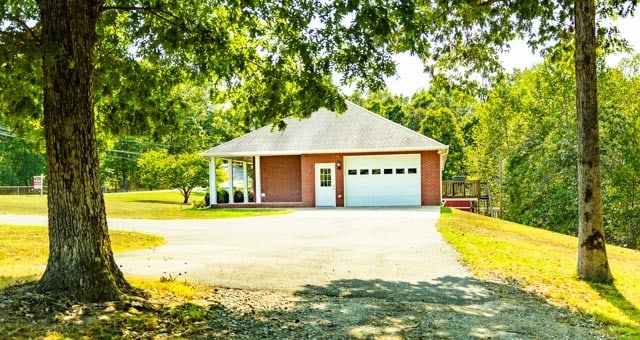 view of front of house with a garage and a front lawn