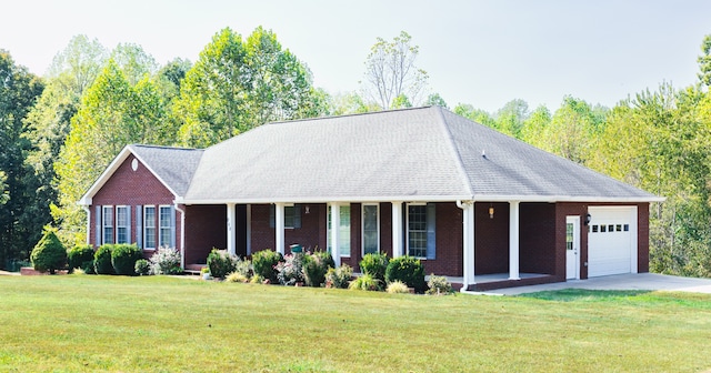 view of front of house featuring a porch, a garage, and a front yard