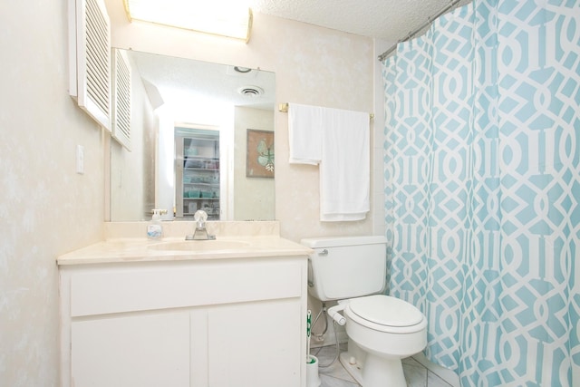 bathroom with toilet, a textured ceiling, tile patterned floors, and vanity