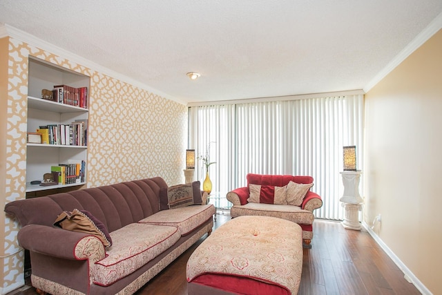 living room featuring hardwood / wood-style flooring, ornamental molding, and a textured ceiling