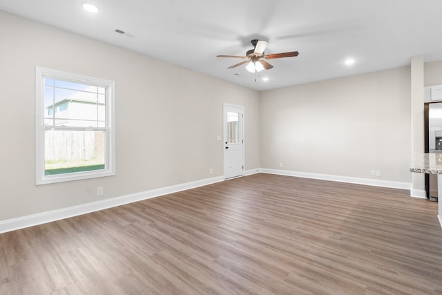 unfurnished living room with hardwood / wood-style floors and ceiling fan