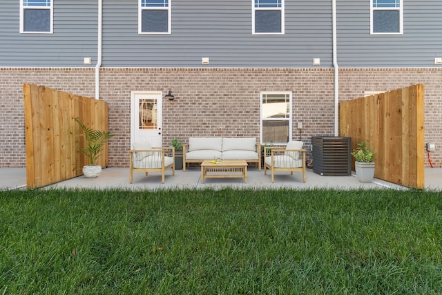 exterior space featuring cooling unit, a patio area, fence, and an outdoor hangout area