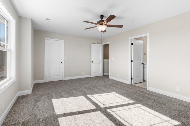 unfurnished bedroom with ceiling fan, carpet floors, visible vents, and baseboards