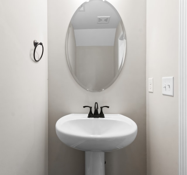 bathroom featuring visible vents and a sink