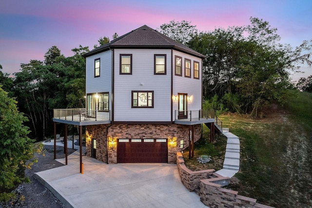 view of front of home featuring stairs, concrete driveway, and a garage