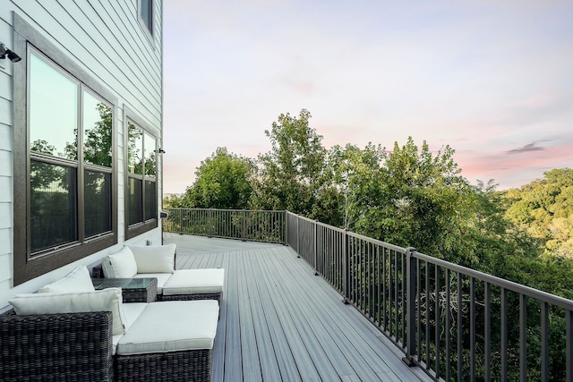 deck at dusk with outdoor lounge area