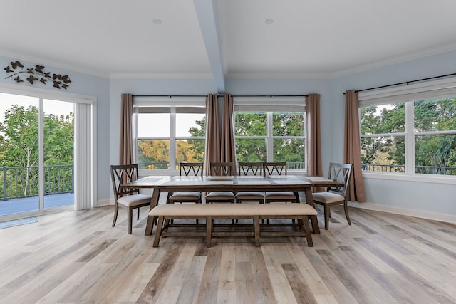 dining area with light hardwood / wood-style flooring, crown molding, and beamed ceiling