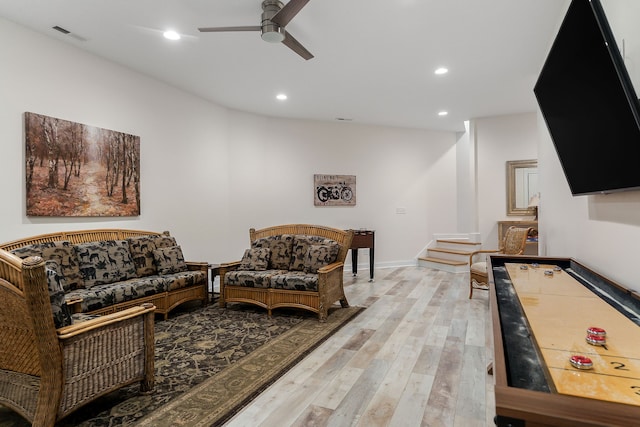 living room featuring ceiling fan and light wood-type flooring