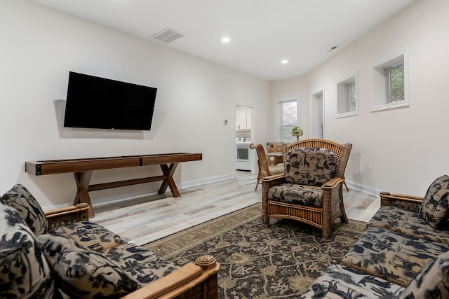 living room featuring a wealth of natural light and dark wood-type flooring