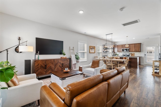 living room featuring dark wood-type flooring and a wealth of natural light