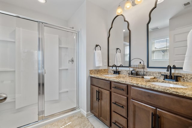 bathroom with vanity and a shower with door