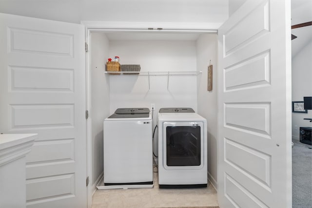 laundry room featuring independent washer and dryer and light tile patterned floors