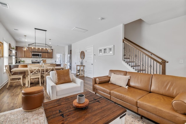 living room featuring hardwood / wood-style floors and an inviting chandelier