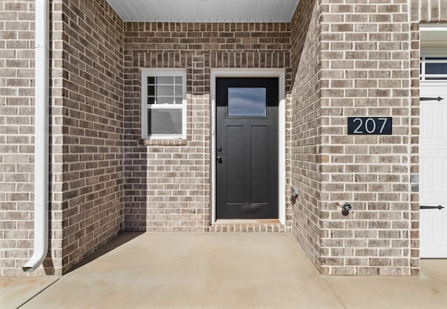 doorway to property with a garage