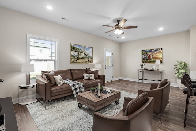 living area with recessed lighting, visible vents, ceiling fan, and wood finished floors