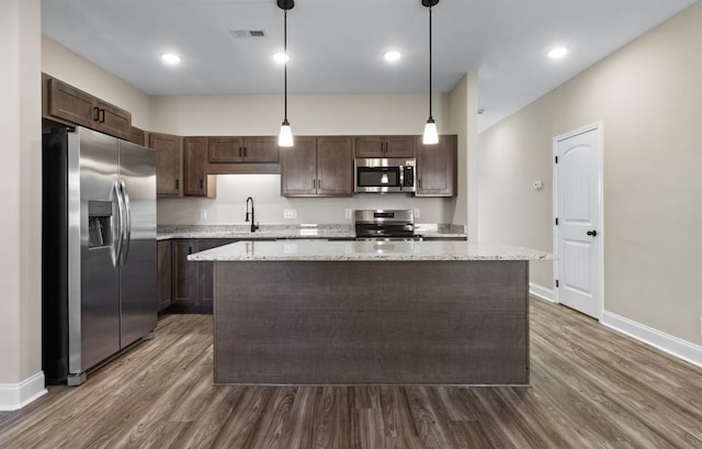 kitchen featuring appliances with stainless steel finishes, dark wood-style flooring, visible vents, and dark brown cabinets