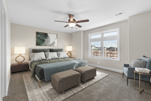 bedroom featuring a ceiling fan, baseboards, visible vents, and carpet flooring