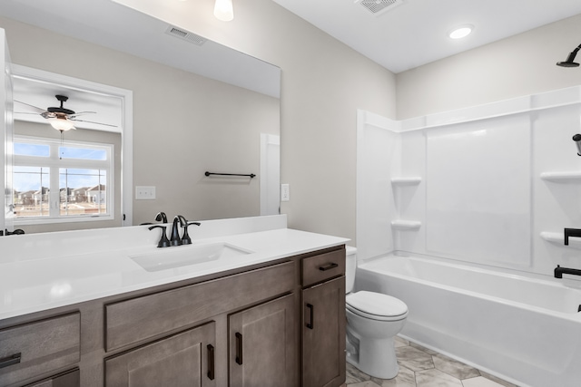 full bath with visible vents, toilet, washtub / shower combination, a ceiling fan, and vanity