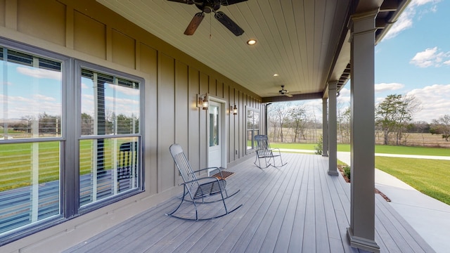 deck with ceiling fan and a yard