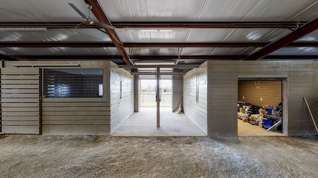 interior space with beamed ceiling and concrete flooring