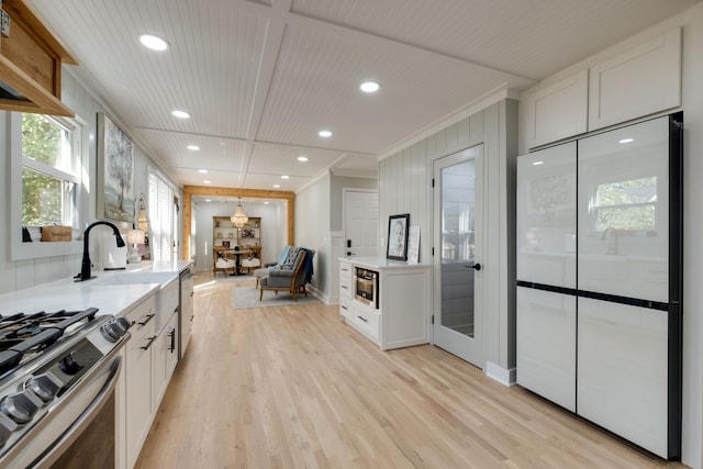 kitchen featuring light wood-type flooring and white cabinetry