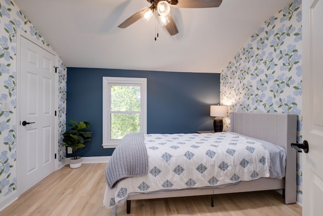 bedroom featuring ceiling fan, vaulted ceiling, and light hardwood / wood-style floors