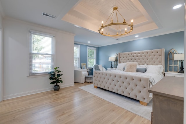 bedroom with a raised ceiling, light hardwood / wood-style flooring, a chandelier, and ornamental molding