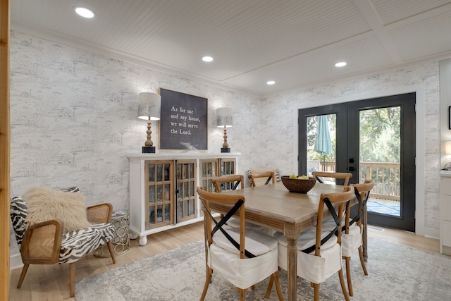 dining space with coffered ceiling, french doors, crown molding, and light hardwood / wood-style flooring