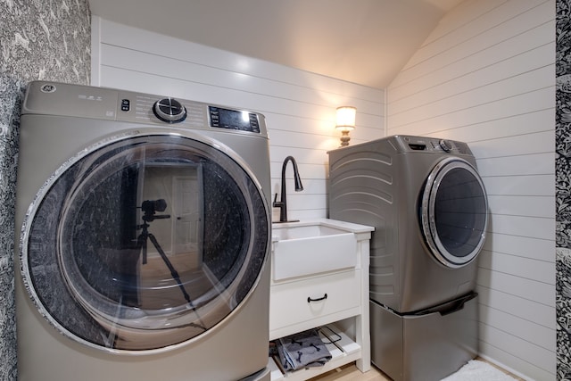 clothes washing area featuring sink and washer and dryer