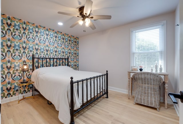 bedroom featuring ceiling fan and light hardwood / wood-style flooring