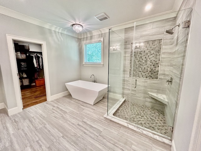 bathroom with a shower with door and ornamental molding