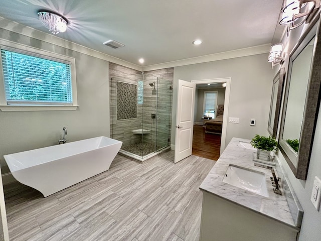 bathroom with independent shower and bath, crown molding, and dual bowl vanity