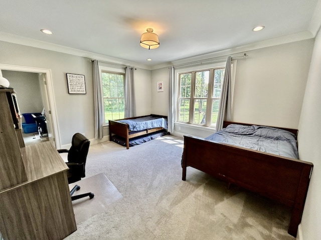 bedroom featuring crown molding, multiple windows, and light colored carpet