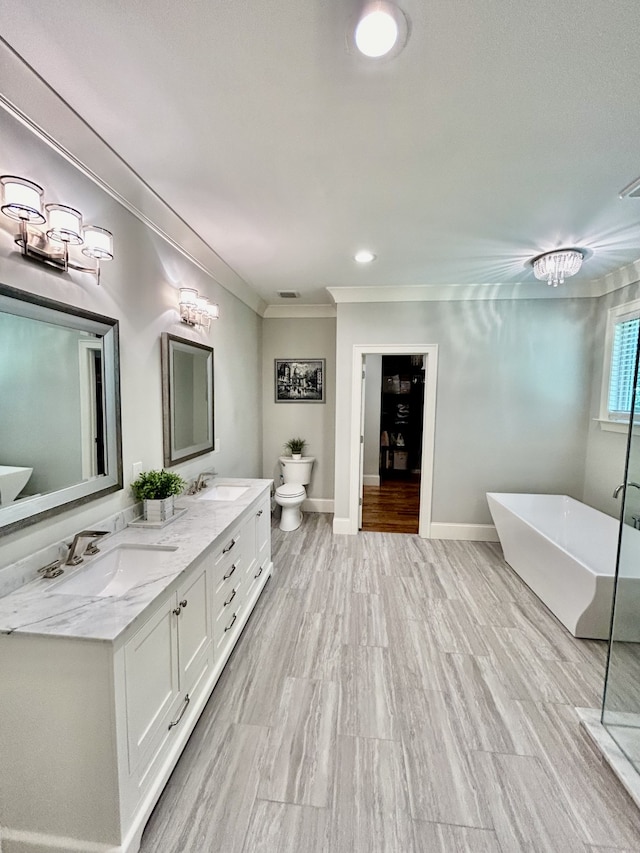 bathroom with a tub, crown molding, wood-type flooring, toilet, and dual vanity