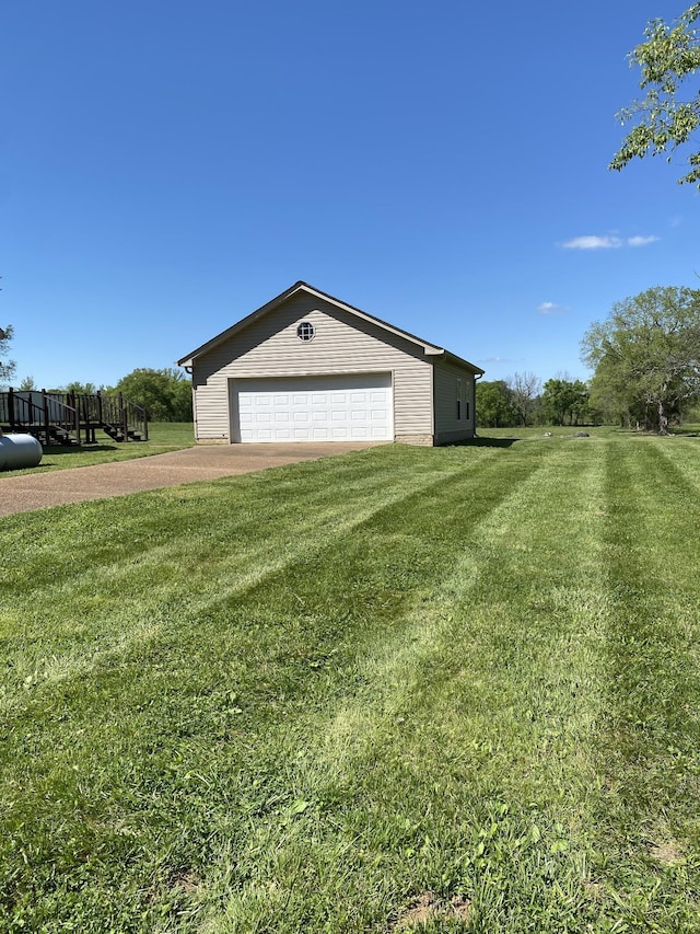 view of property exterior featuring an outbuilding, a garage, and a yard