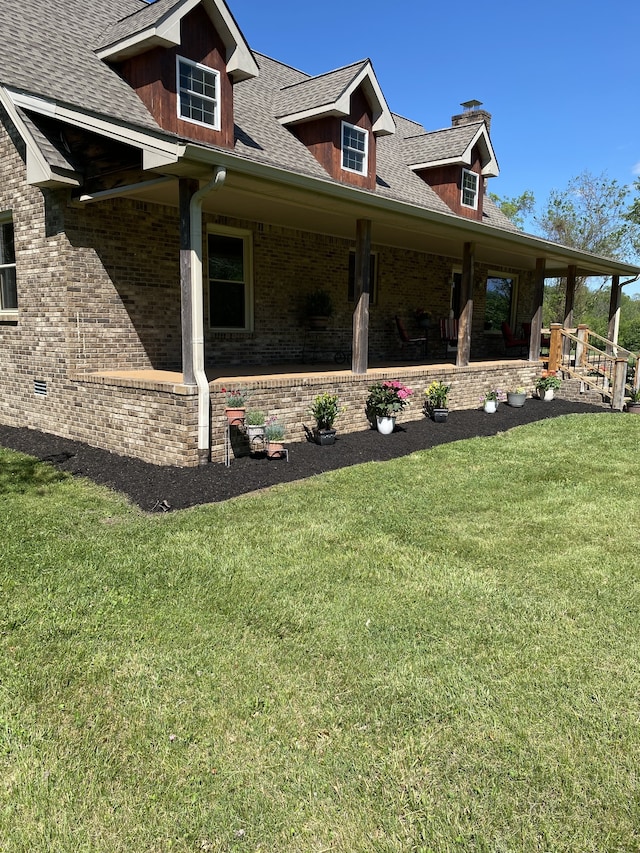 view of property exterior with a porch and a lawn